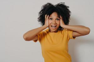 Woman plugging ears with hands does not want to listen hard rock or loud music photo