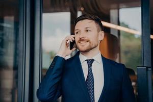 Male business owner hearing good news over phone photo