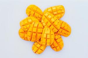 rebanadas de mango maduro amarillo sobre fondo blanco. Fruta tropical de verano rica en vitaminas. vista superior. rebanadas o cubos de mango. corte de mango