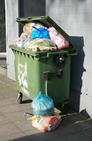 overflowing garbage container photo