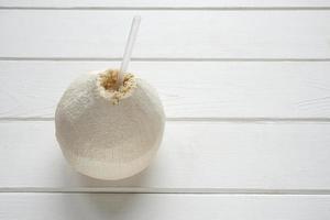 fresh coconut with drinking straw photo