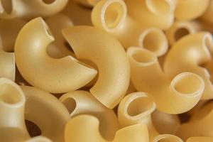 Raw macaroni. Curved hollow horns for making macaroni cheese. photo
