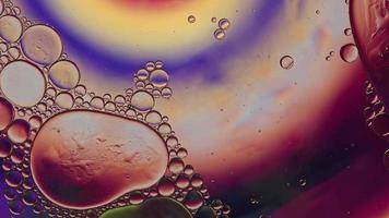 Abstract Colorful Food Oil Drops Bubbles and spheres Flowing on Water Surface, macro Videography video