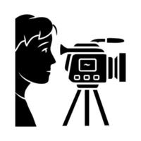 Cameraman glyph icon. Videorecording, filming. Videographer, operator with camera. Video journalist, reporter. Filmmaking. Silhouette symbol. Negative space. Vector isolated illustration