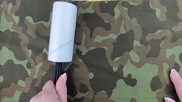Contamination with cat hair, hair and dust from fabrics. Roller with a sticky layer. video