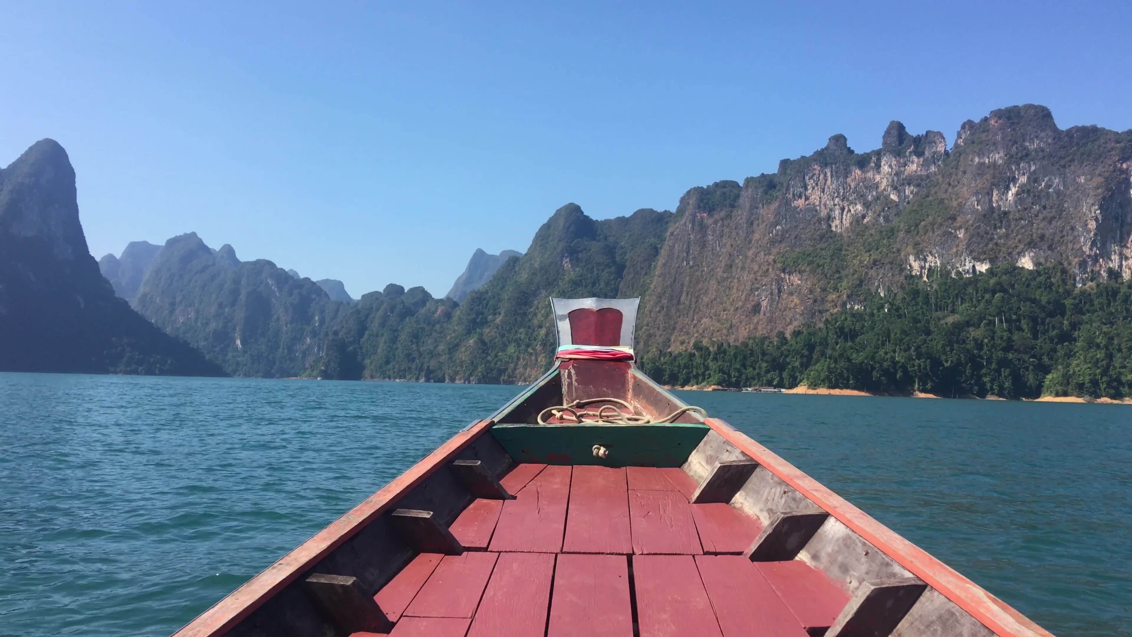 Thai wooden head long tail boat heads toward the tropical Andaman