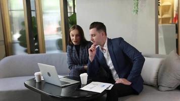 Two young colleagues chatting together on a break. startup business people group working everyday job at modern office. video