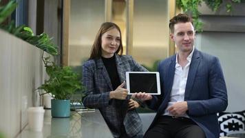 Two young colleagues chatting together on a break. startup business people group working everyday job at modern office. video