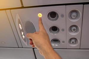 Flight attendant call button. Air conditioning in the plane. photo