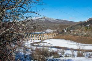 railroad bridge across the snowy valley photo
