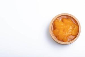 Pickled peeled oranges in syrup in a cup.on a white background. photo