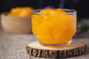 Orange in syrup in clear dessert glass photo