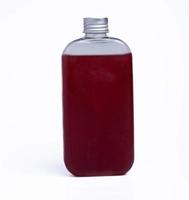 Grape juice in a clear bottle on a white background photo