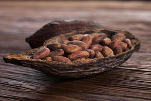 Cocoa pod on wooden background photo