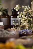 Alternative medicine, dried herbs and mortar on wooden desk background photo