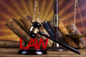 Law theme, mallet of the judge, wooden desk background photo