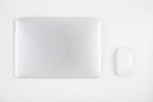 Top view of laptop computer with closed and mouse isolated on white background, notebook or netbook, communication technology concept. photo