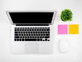 Top view of laptop computer with open display screen monitor, mouse and notepad isolated on white background, notebook or netbook with keyboard, communication technology concept. photo