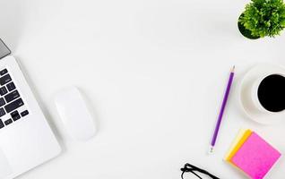 Top view of laptop computer with open display screen monitor, mouse and notepad, glasses and pencil isolated on white background, notebook or netbook with keyboard, communication technology concept. photo