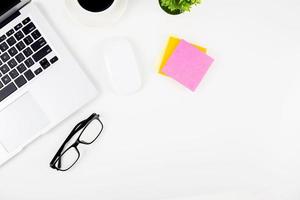 Top view laptop with open display screen monitor, diary and mouse and notepad and glasses isolated on white background, notebook or netbook with keyboard, communication technology on work office. photo