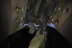 Drone male inspection operated by construction worker on furnace photo