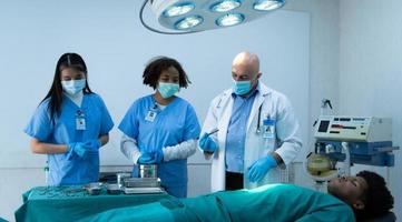 A medical professor is teaching surgery to medical students working photo