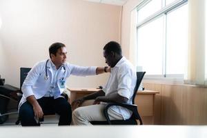 A hospital doctor is examining the symptoms of an inpatient photo