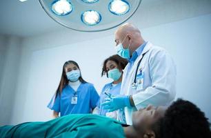 A medical professor is teaching surgery to medical students working photo