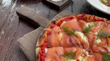 pizza de salmón ahumado en bandeja de madera video