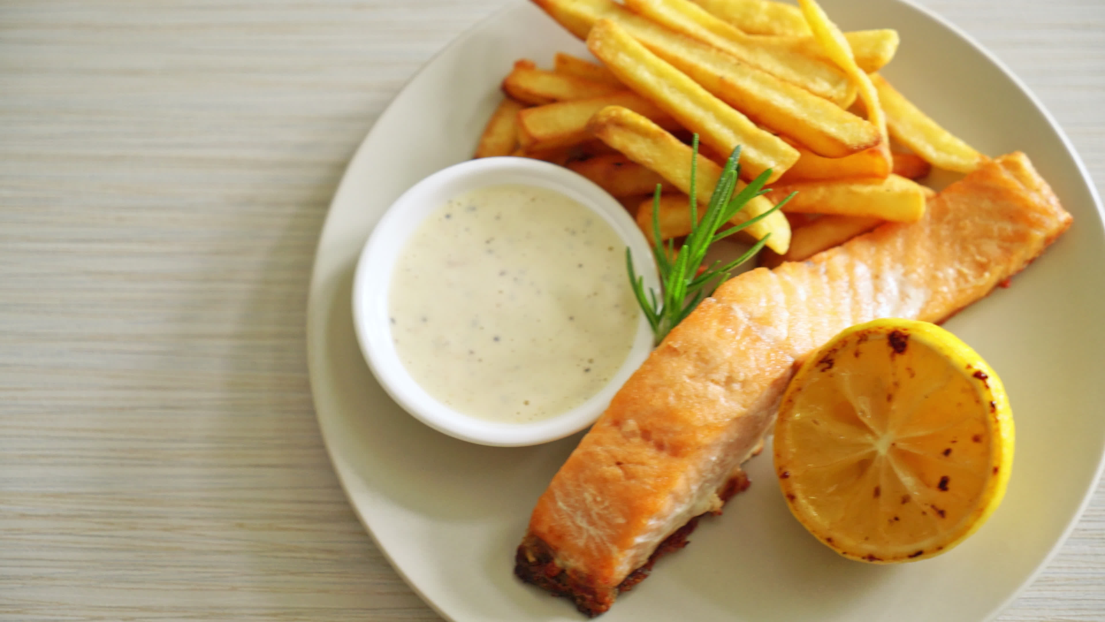fried salmon fish and chips with lemon on plate 7502137 Stock Video at Vecteezy