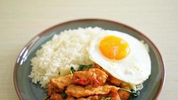 stir-fried fried fish with basil and fried egg topped on rice - Asian food style video