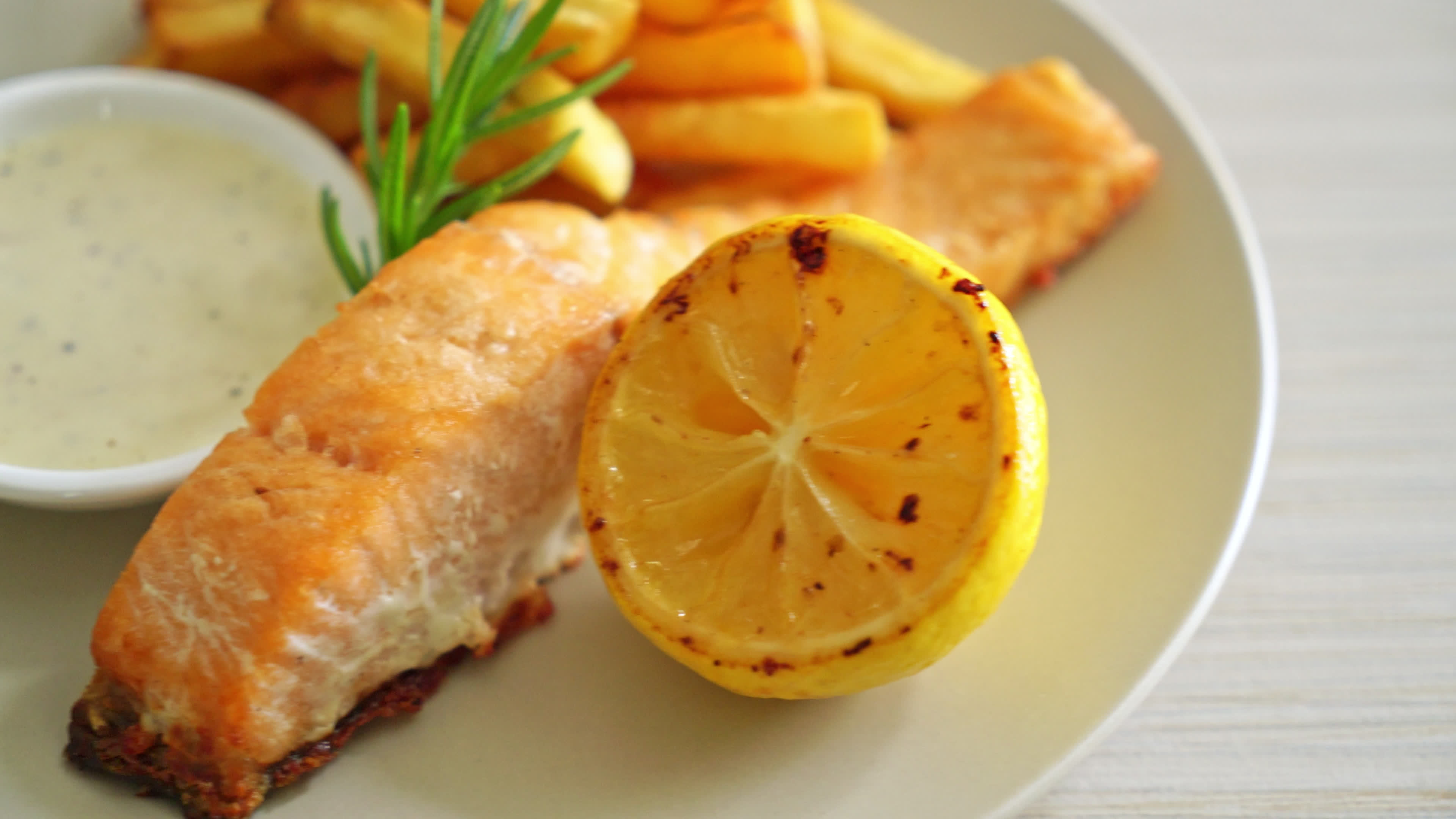 fried salmon fish and chips with lemon on plate 7502419 Stock Video at Vecteezy