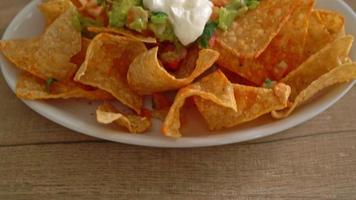 Mexican nachos tortilla chips with jalapeno, guacamole, tomatoes salsa and dip video