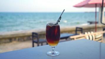 iced americano coffee peach with ocean sea background video