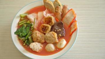 noodles with meatballs in pink soup or Yen Ta Four Noodles in Asian style video