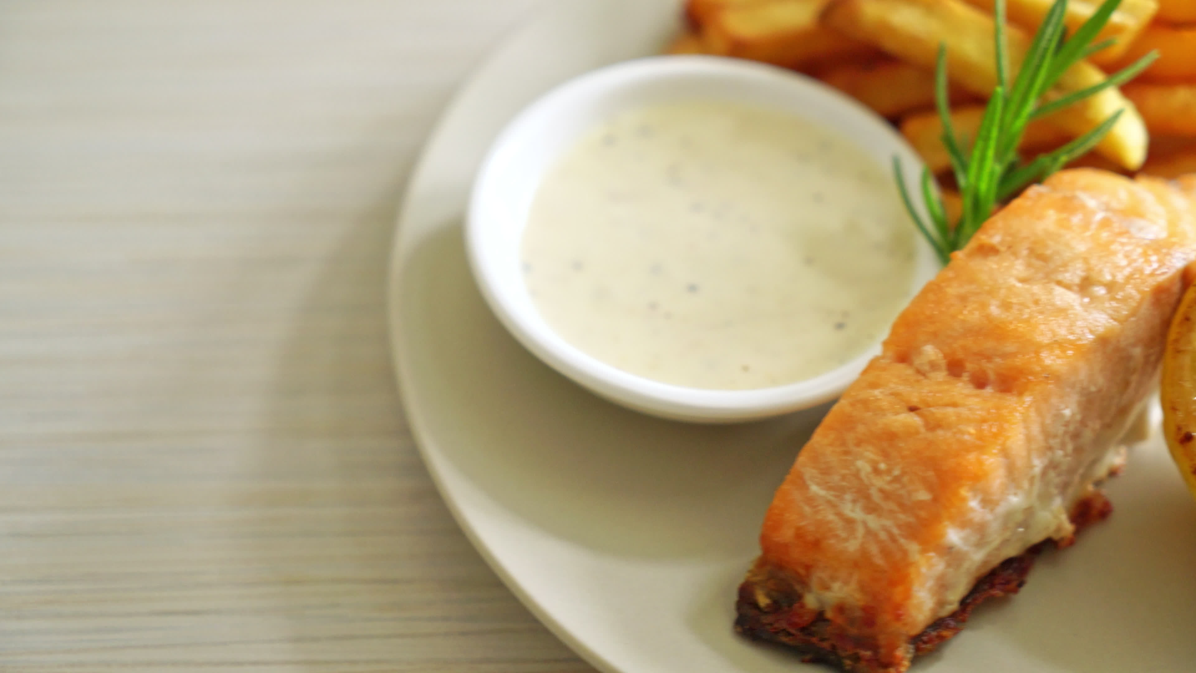 fried salmon fish and chips with lemon on plate 7502908 Stock Video at Vecteezy