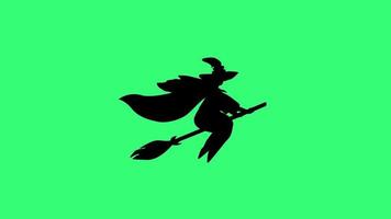Black silhouette of a witch isolated on green background. Seamlessly looped animation video