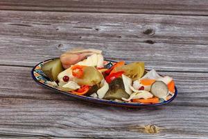 Pickled vegetables mix in the plate photo