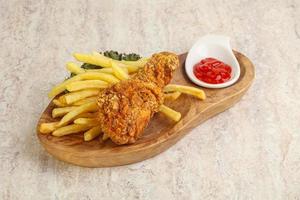 Crispy chicken leg with fry potato photo