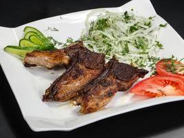 Grilled lamb chops served onion photo