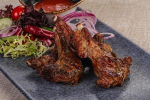Grilled lamb chops with sauce photo