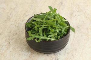 Fresh green arugula in the bowl photo