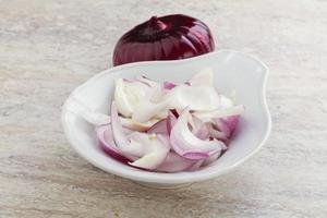 Sliced red onion in the bowl photo