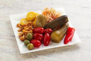 Plate with pickled vegetables and mushrooms photo