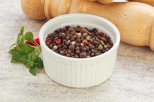 Peppercorn mix heap in the bowl photo