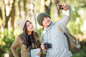 Young couple tourist travel in mountain forest photo