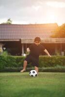 Little Boy playing soccer football photo