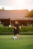 Little Boy playing soccer football photo