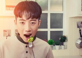 handsome young men eating salad look at camera close up shoot photo