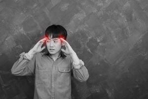 Headache handsome young man posing against a grunge background photo